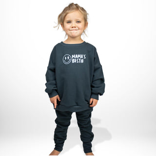 Child modeling blue crewneck sweatshirt featuring 'Mama's Bestie' graphic, oversized fit by My Mini Explorer