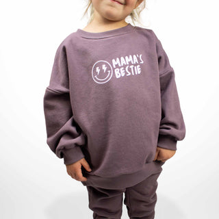 Child modeling purple crewneck sweatshirt featuring 'Mama's Bestie' graphic, oversized fit by My Mini Explorer