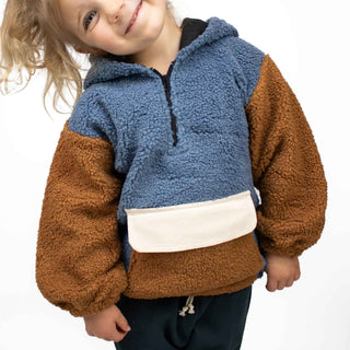 Child wearing My Mini Explorer sherpa hoodie with quarter zip and kangaroo pocket in a white studio setting, showcasing the true-to-size fit and cozy design.