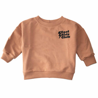 Flat lay of Sunbake-colored Cool Kids Club crewneck featuring lightning bolt graphic, showcasing oversized fit and organic cotton spandex blend for comfort and flexibility. Designed by My Mini Explorer for young adventurers.