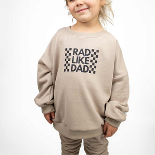 Child wearing Rad Like Dad crewneck sweatshirt in beige, showcasing oversized style  by My Mini Explorer. 