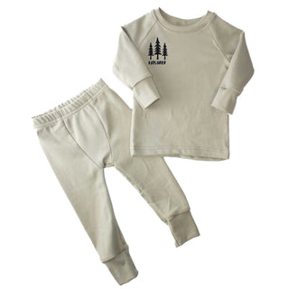 Flat lay of sage-colored Cotton-Tencel pajama set by My Mini Explorer, featuring 'Explorer' vinyl design with tree graphics. Soft, eco-friendly fabric perfect for layering or standalone wear