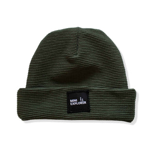 Forest green colored thermal fabric beanie with a patch saying "mini explorer". 