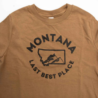 Brown t-shirt with a graphic design stating "Montana Last Best Place". Close up of the neckline.