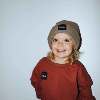 Mushroom colored thermal beanie with a custom patch stating "Mini Explorer". Included in the picture is our signature crewneck in tawny with the same custom patch. Handmade by My Mini Explorer in their family owned and operated workshop. 