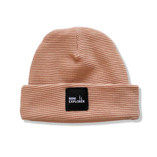 Rose clay colored thermal beanie with a custom patch stating "Mini Explorer". Handmade by My Mini Explorer in their family owned and operated workshop. 